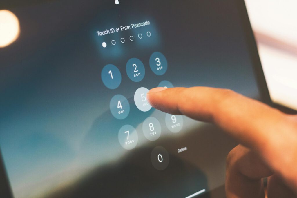 Person entering a passkey into their iPhone as part of multi-factor authentication setup.