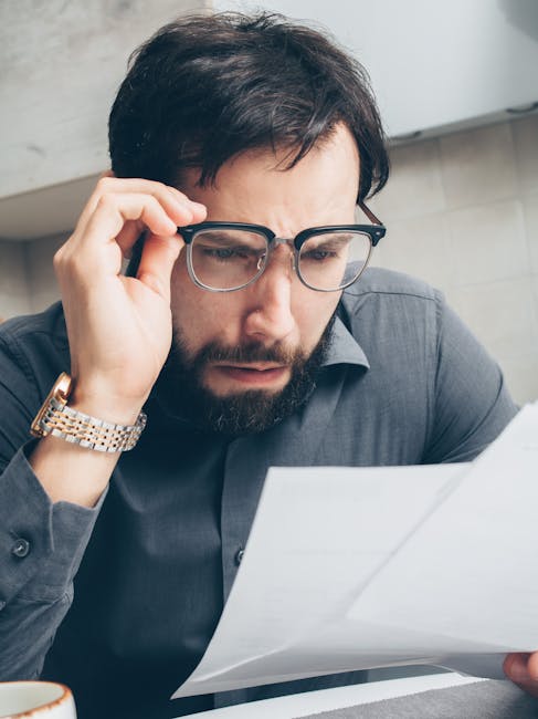 password-reset-in-home-support Perplexed man at desk struggling with login, representing password reset help in the London area