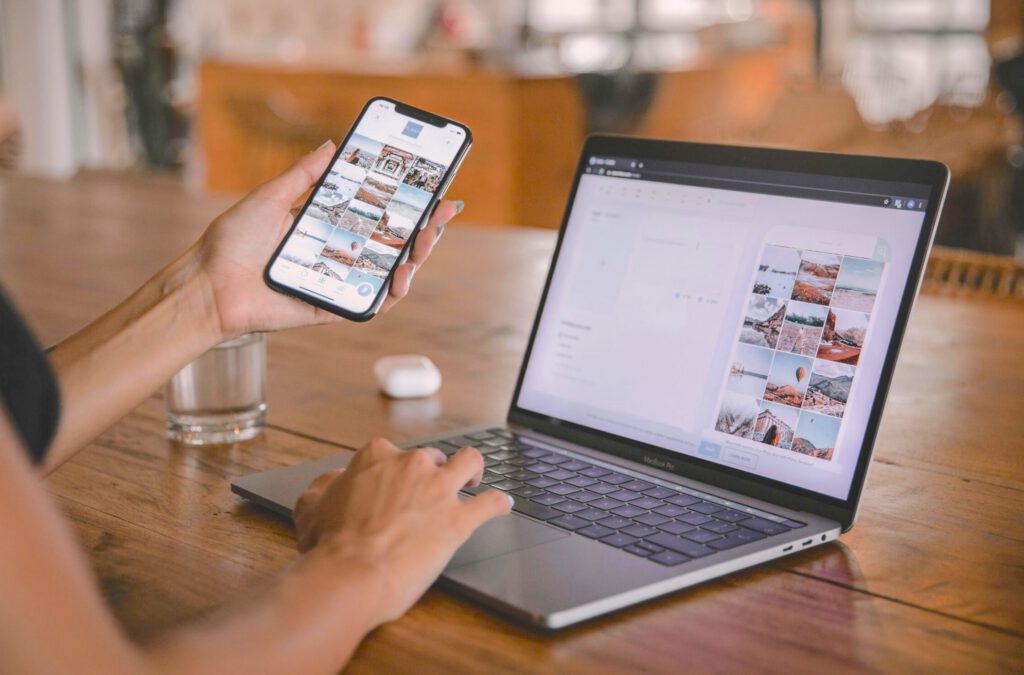 Woman using AirDrop to transfer photos from iPhone to Mac.