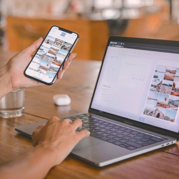Woman using AirDrop to transfer photos from iPhone to Mac.